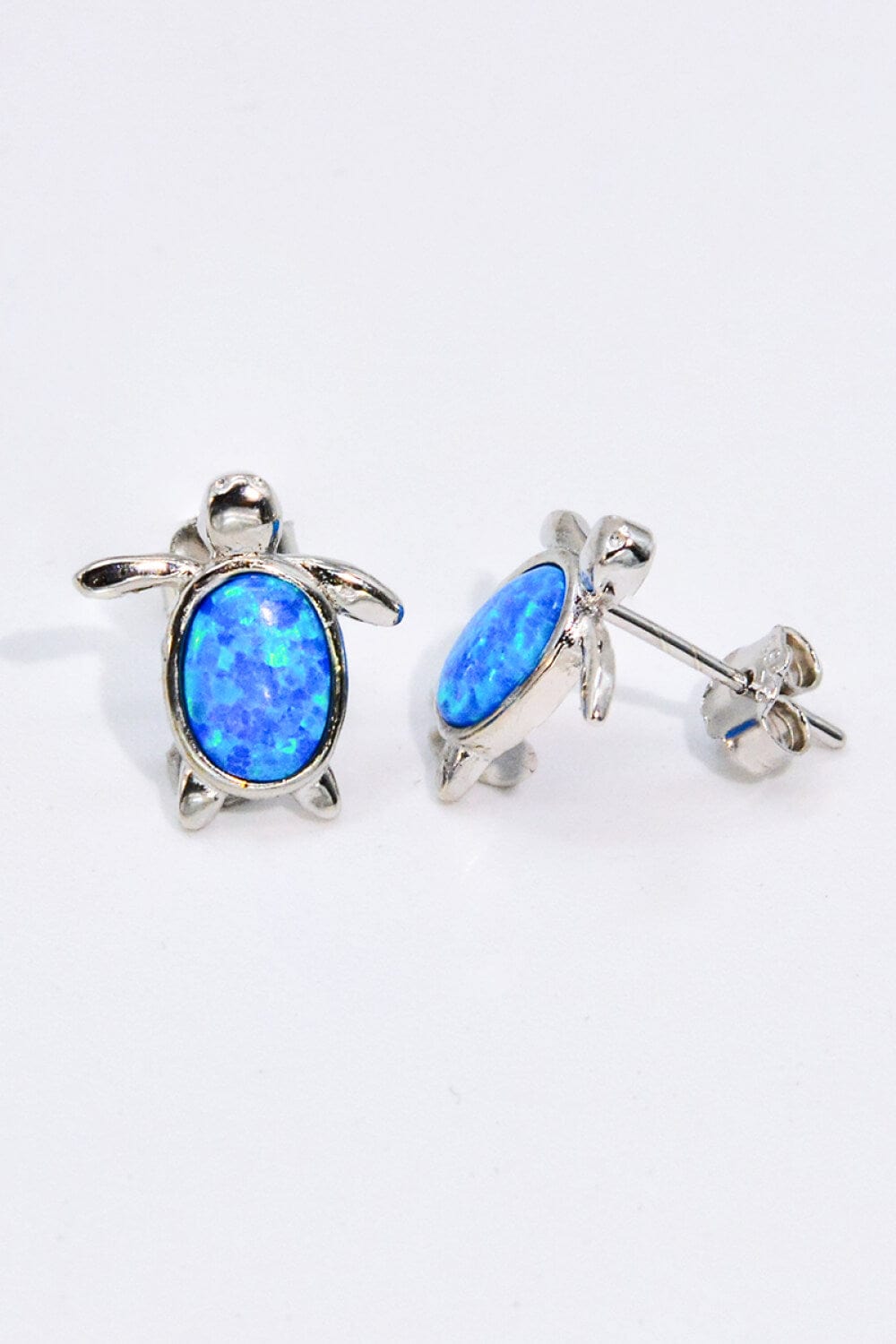 crystal blue opals with flecks of lighter blues and hues to look like shimmering water. The opals are set in pewter.