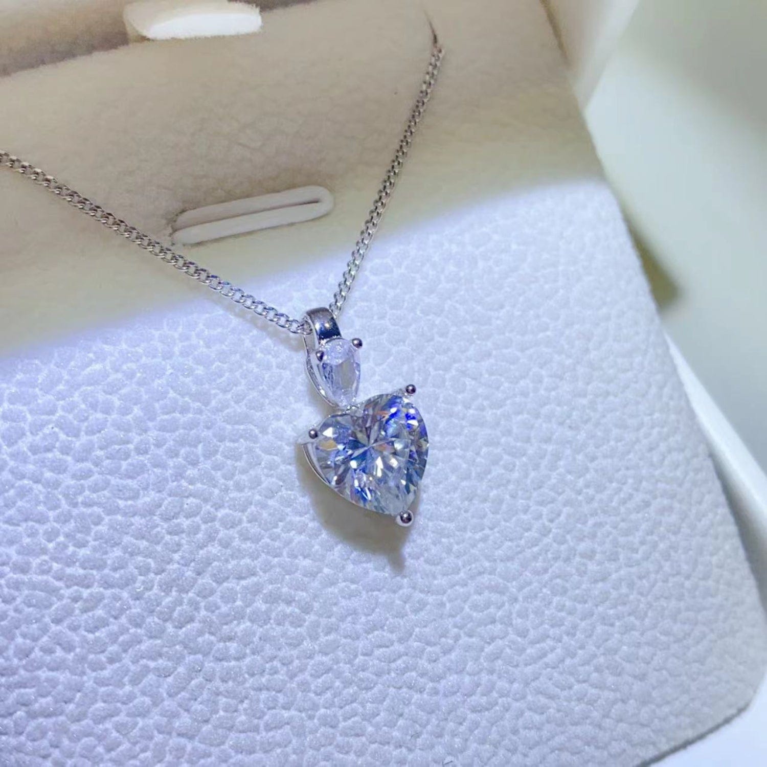 white heart shaped moissanite, gives off flecks of multiple colors, its sweet but still very elegant. 